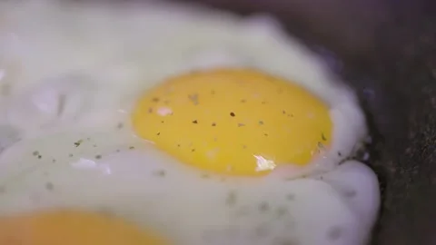 Egg breaks and flows into the pan. Healthy breakfast concept. Close up view Stock Footage 194509601