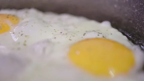 Egg breaks and flows into the pan. Healthy breakfast concept. Close up view Stock Footage 194510082
