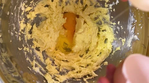 Egg is broken and dropped into the dough Stock-Footage 228725283