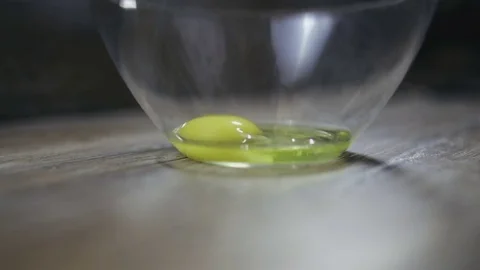 Egg is broken into a bowl close-up Stock Footage 72995771
