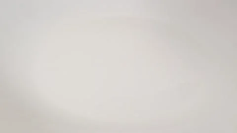 Egg broken into a plate close up Stock Footage 117444606