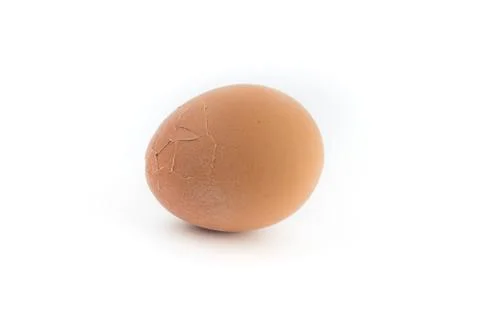 Egg with broken shell closeup on white background. Stock Photos