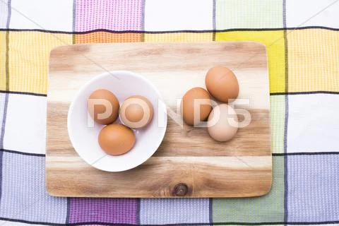 Egg, Brown Eggs in White Plate on Wooden Board, Top View Stock Photos