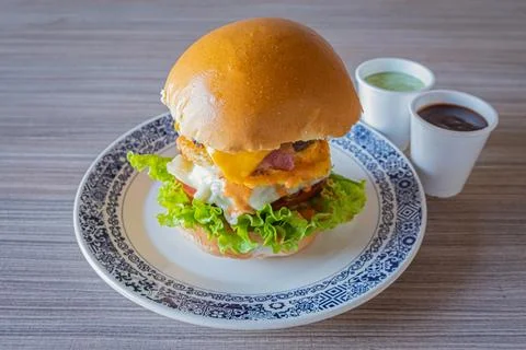 Egg burger composition served with assorted sauces Foto stock