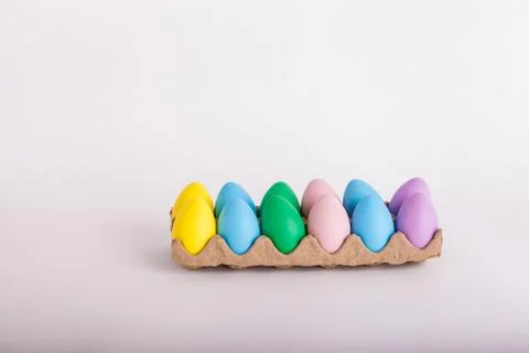Egg carton with pastel colored Easter eggs Stock Photos