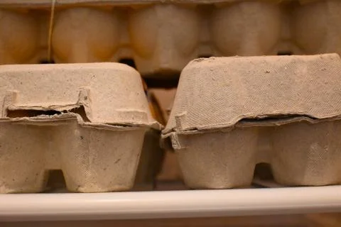 Egg cartons on a shelf Stockfoto's