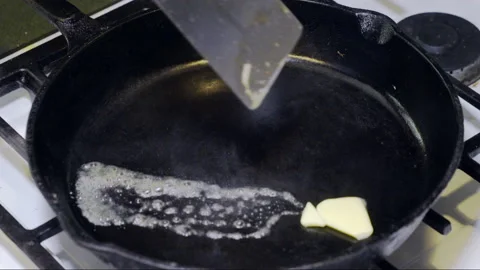 Egg in Cast Iron Skillet Stock Footage 149090794