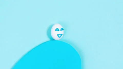 An egg with a cheerful expression rushing on a wave of good luck.  Stock Footage 220230401