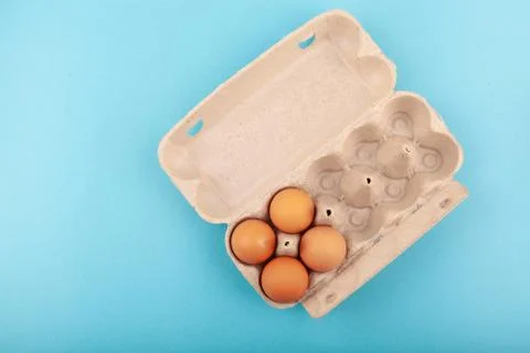 Egg Chicken eggs. Top view of an open gray box with brown eggs Isolated on a Stock Photos