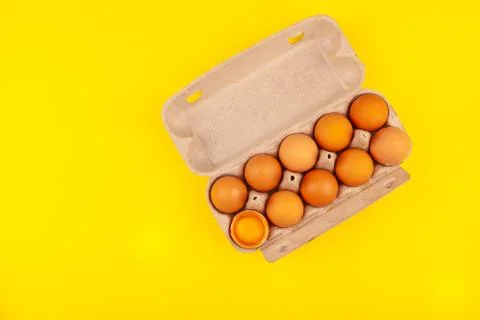 Egg Chicken eggs. Top view of an open gray box with brown eggs Isolated on a Stock Photos