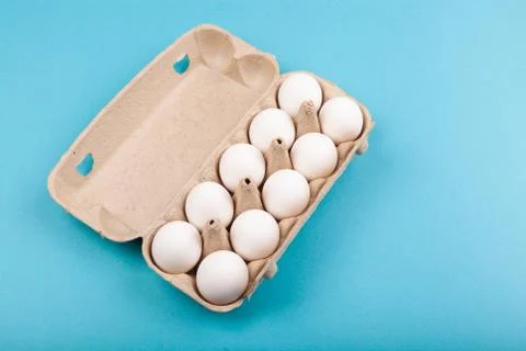 Egg Chicken eggs. Top view of an open gray box with white eggs. Isolated on a Stock Photos