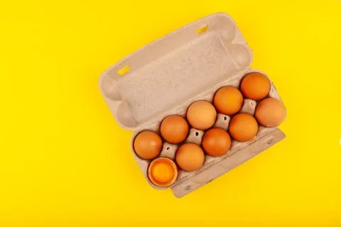 Egg Chicken eggs. Top view of an open gray box with brown eggs Isolated on a Stock Photos