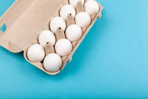 Egg Chicken eggs. Top view of an open gray box with white eggs. Isolated on a Stock Photos