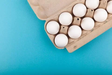 Egg Chicken eggs. Top view of an open gray box with white eggs. Isolated on a Stock Photos