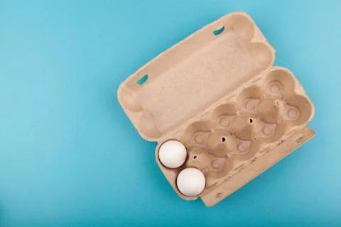 Egg Chicken eggs. Top view of an open gray box with white eggs. Isolated on a Stock Photos