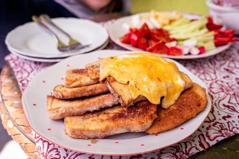Egg coated fried bread, salty French toast with vegetables, outdoors brunch Stock Photos