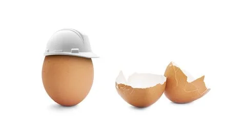Egg with a construction helmet and broken egg Stock Photos
