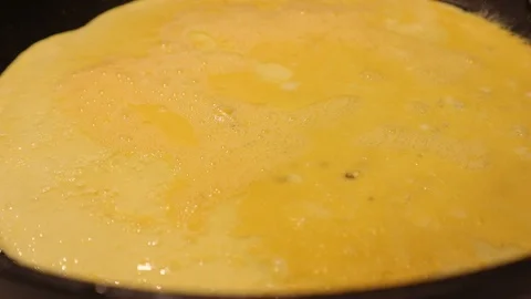 Egg Cooking in Pan as Base for Omelette Stock Footage 124794273