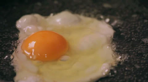Egg cooks on frying pan Stock Footage 37796805