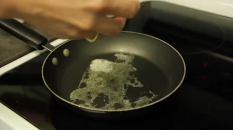 Egg Crack and Drop in Skillet with Butter Stock Footage 28809056