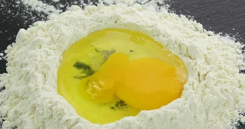 Egg crack in to the flour Stock Footage