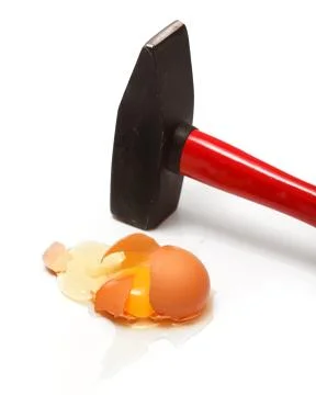 Egg cracked with hammer 스톡 사진