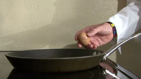 Egg cracked over pan breaks yolk Video stock 994109