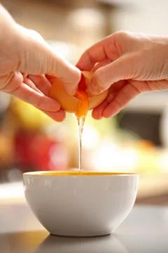 Egg cracking Stock Photos