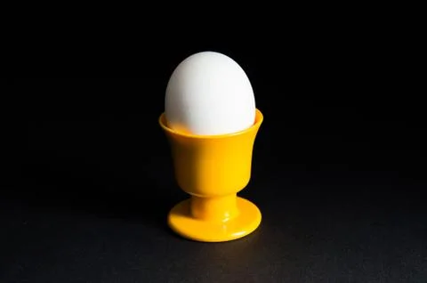 Egg in cup at black background Stock Photos
