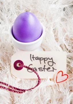 Egg cup with purple easter egg Stock Photos