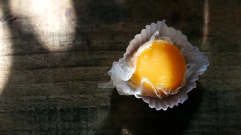 An egg custard on the table. Close-up of an Egg yolk custard with coconut Stock Footage 276718399