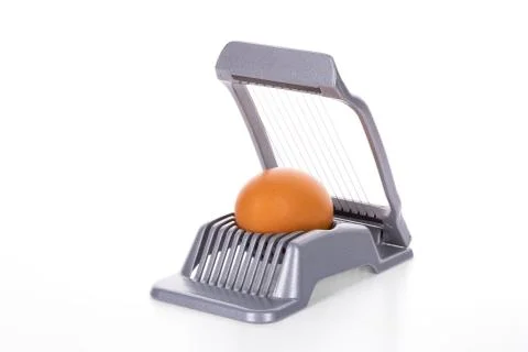 Egg cutter - slicer with brown egg on white Stock Photos