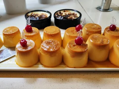 Egg dessert pudding with cherry decor close-up 库存照片