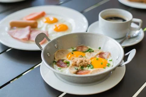 Egg dish Breakfast served with fried egg, ham, orange juice, delicious. Stock Photos