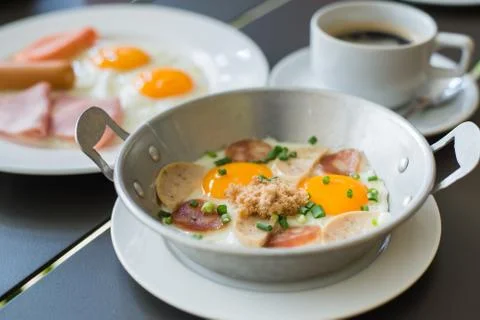 Egg dish Breakfast served with fried egg, ham, orange juice, delicious. Stock Photos