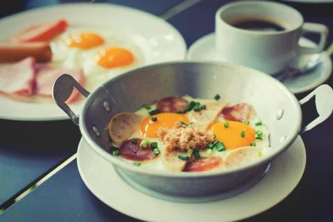 Egg dish Breakfast served with fried egg, ham, orange juice, delicious. Stock Photos