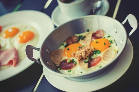 Egg dish Breakfast served with fried egg, ham, orange juice, delicious. Stock Photos