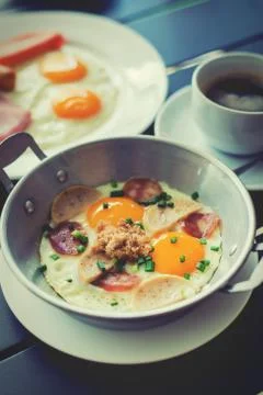 Egg dish Breakfast served with fried egg, ham, orange juice, delicious. Stock Photos