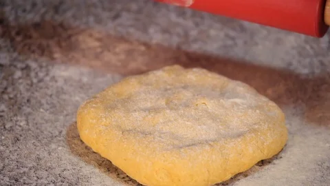 Egg dough rolled out with a rolling pin - slow motion Stock Footage 98176236