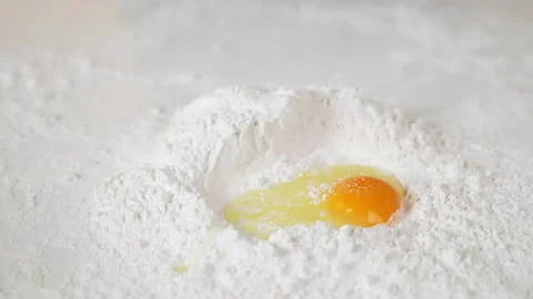 Egg drop on flour on the table with for making various desserts. 스톡 동영상 153963093