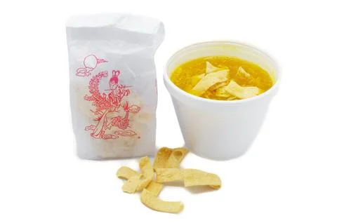 Egg drop or egg flower soup is a Chinese soup of wispy beaten eggs in chick.. Stock Photos