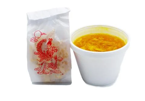 Egg drop or egg flower soup is a Chinese soup of wispy beaten eggs in chick.. Stock Photos