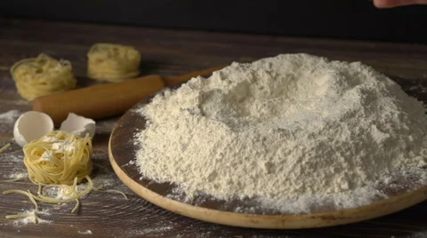Egg dropping into flour, slow motion Stock Footage 62068874