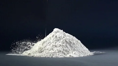 Egg dropping into flour in slow motion. Stock Footage