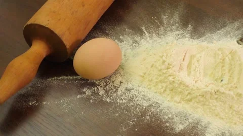 Egg dropping into heap of flour Stock Footage 68368043