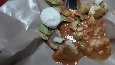 Egg dumplings that have been smeared with peanut sauce which is very delicious Stock Footage 224406745