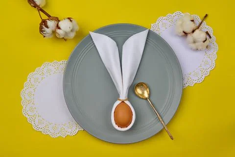 Egg with ears on a plate with a spoon Stock Photos
