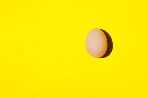 An egg. An egg on a yellow background. Egg background close-up. Fotos Stock