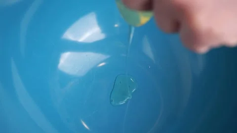 Egg falling into blue plate in slow motion Stock Footage 310029794