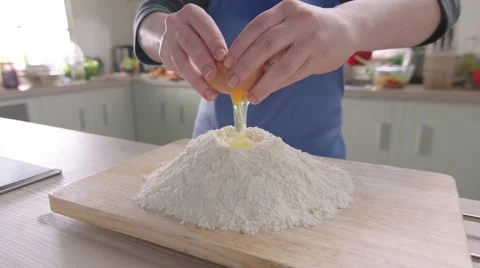 Egg falling into the flour Stock Footage 46458162